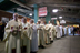 Nearly 100 priests—faculty and alumni, Jesuit, diocesan, and from other orders—joined University President William P. Leahy, SJ, as concelebrants of the Mass. They waited under the stands for the start of the procession that would take them from the right field foul pole (locally dubbed the Pesky Pole) to the altar on the first base line near home plate. In the foreground, from left, are James Keenan, SJ, the Founders Professor of Theology; Rev. Joseph Marchese, director of the Office of First Year Experience; Mark Massa, SJ, dean of the School of Theology and Ministry; and Rev. Robert Imbelli, associate professor of theology.<br/>Photograph by Caitlin Cunningham